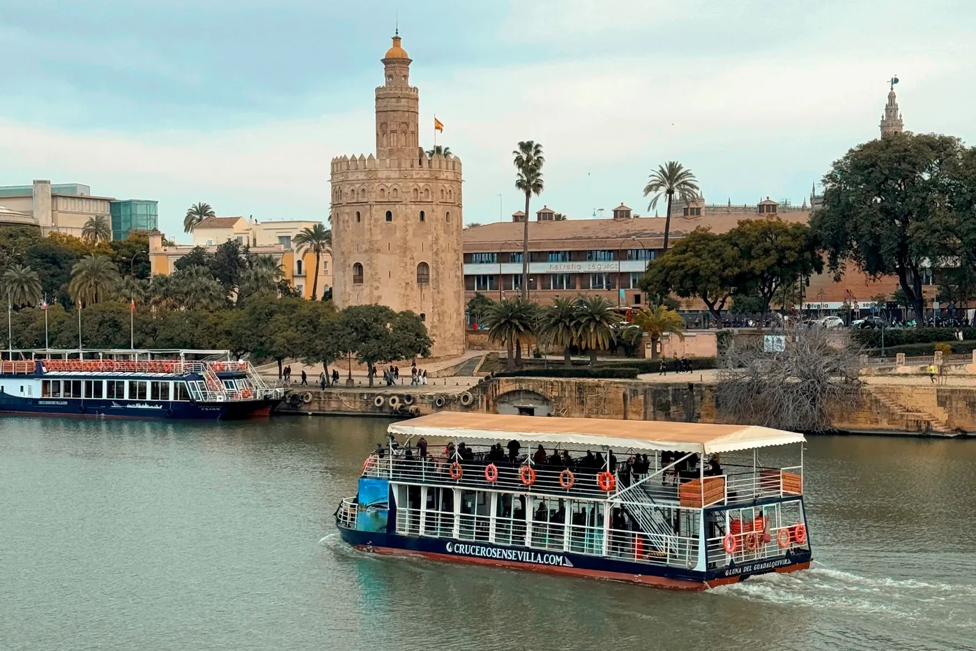 Cruise boat passing the Torre del Oro on the Guadalquivir