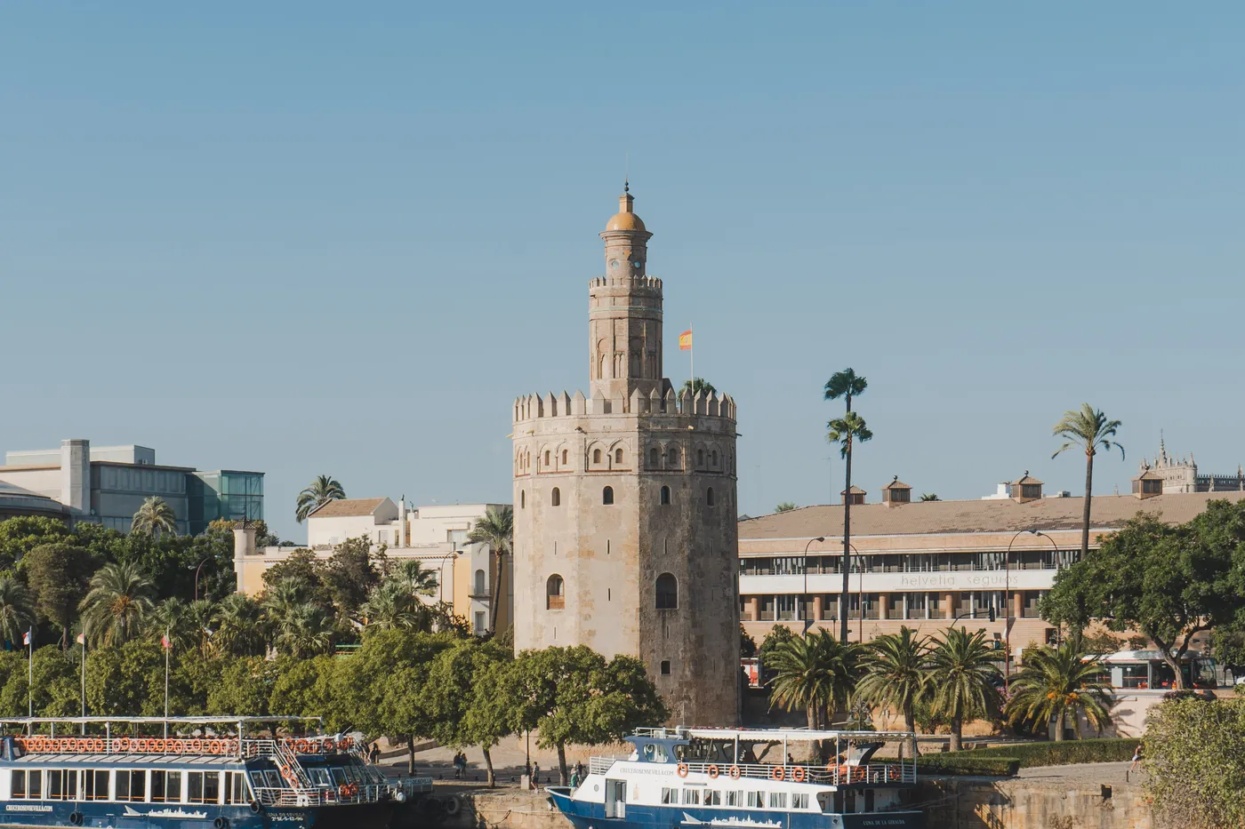 Torre del Oro and cruise boats moored at the jetty